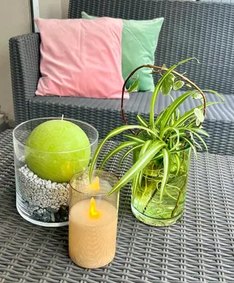 a table with a potted plant and candles on it at Le Victor Hugo de la Robine in Narbonne