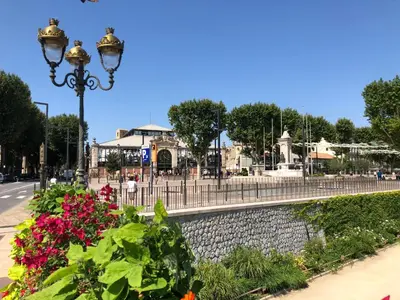 a street light and flowers on a street at Le Victor Hugo de la Robine in Narbonne