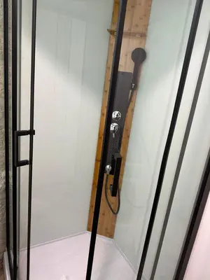 a glass door with a shower in a room at Studio familial a Mezzanine presbytère dans l'Église in Narbonne
