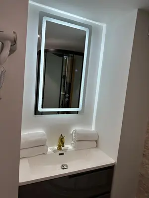 a bathroom with a white sink and a mirror at Studio familial a Mezzanine presbytère dans l'Église in Narbonne