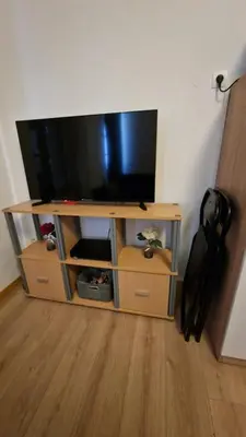 a entertainment center with a flat screen tv on it at Appartement T2 avec balcon proche centre-ville NARBONNE in Narbonne