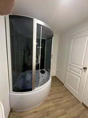 a bathroom with a tub in the middle of a room at Suite a Mezzanine dans l'Église du Couvent in Narbonne