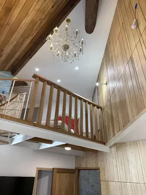 a staircase in a house with a chandelier at Suite a Mezzanine dans l'Église du Couvent in Narbonne