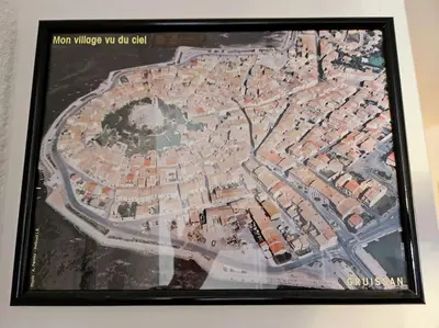 a framed picture of a map of a city at Logis des Palmiers YourHostHelper in Gruissan