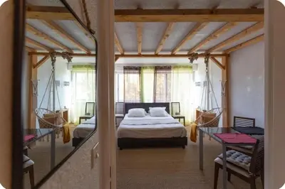 a bedroom with a bed and a hammock at Studio L'air marin in Gruissan