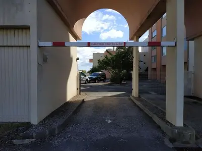 an entrance to a building with a street sign on it at Studio L'air marin in Gruissan