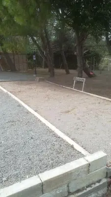 a park with a playground with a sign in the dirt at Gîte aux Aspres Logement de 65m² (4pers) in Fontcouverte