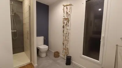 a bathroom with a toilet and a glass shower at Le Chant des Pierres in Saint-Pierre-des-Champs