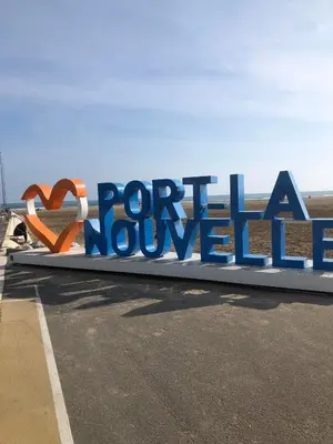 a beach with rocks and the ocean on a sunny day at MOBILE HOME Clim-Piscine -Terrasse -Parking -6 personnes in Port-la-Nouvelle