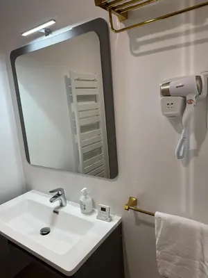 a bathroom with a sink and a large mirror at Studio dans L'Eglise du Couvent in Narbonne