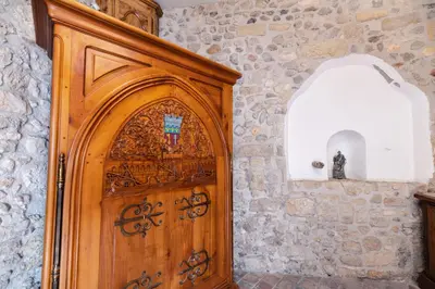 a wooden door in a room with a stone wall at Studio dans L'Eglise du Couvent in Narbonne