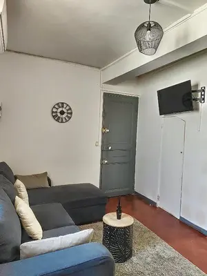 a living room with a couch and a tv at Le Barès in Carcassonne