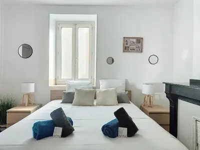 a bedroom with a bed with two pillows on it at Le Barès in Carcassonne