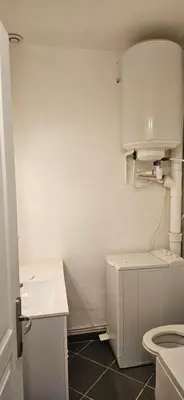 a white bathroom with a toilet and a sink at Clim et extérieur entre mer, garrigue et réserve africaine in Portel-des-Corbières