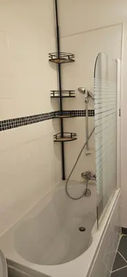 a bathroom with a bath tub with a shower at Clim et extérieur entre mer, garrigue et réserve africaine in Portel-des-Corbières