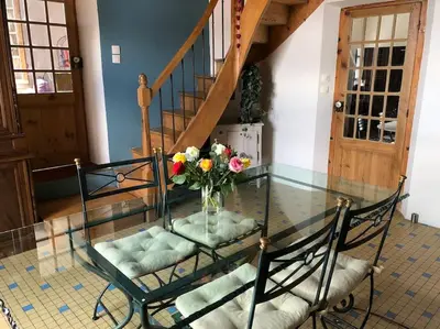 a glass table with a vase of flowers on it at Maison de charme avec vue sur la cité médiévale. in Carcassonne