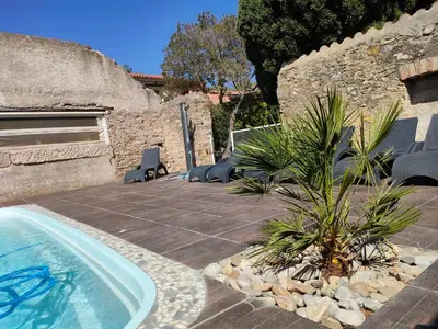 a swimming pool with chairs and a plant in a yard at Hôtel Restaurant L'Art des Mets by Côté Jardin in Conilhac-Corbières