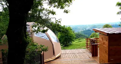 a boat sitting on top of a wooden deck at Le Mobil'Dôme à Marie in Cambounès