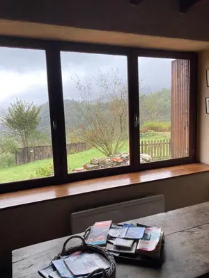 a table with a window with a view of a field at Gîte col de la lauze avec vue sur le château de Montségur in Montferrier