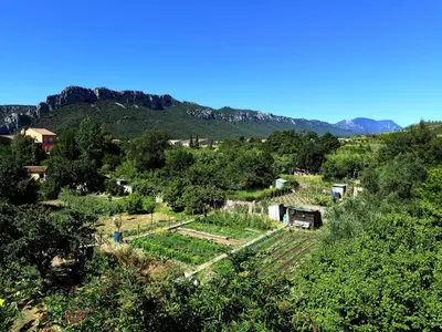 an aerial view of a farm with mountains in the background at hOMe-Shanti Galamus -- Relais Rando - vélo - moto in Saint-Paul-de-Fenouillet