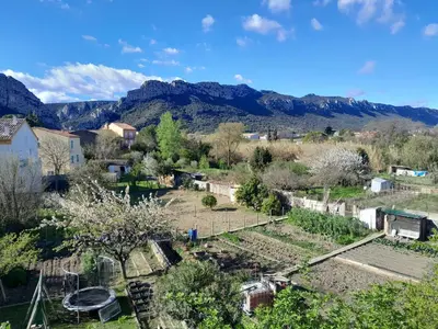 an overview of a garden with mountains in the background at hOMe-Shanti Galamus -- Relais Rando - vélo - moto in Saint-Paul-de-Fenouillet