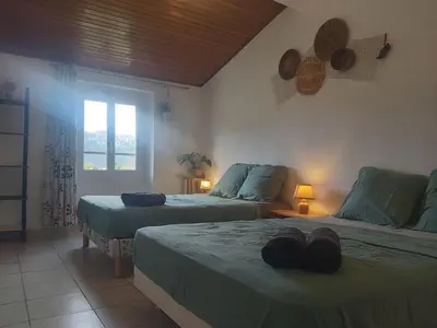 a bedroom with two beds and a window at hOMe-Shanti Galamus -- Relais Rando - vélo - moto in Saint-Paul-de-Fenouillet