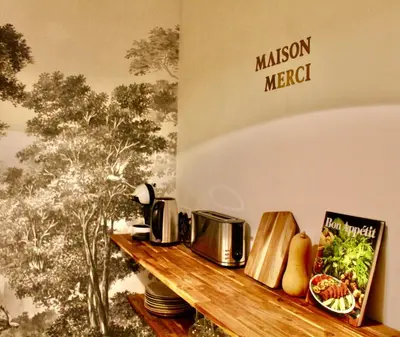 a wooden shelf with a microwave and some food on it at Maison Merci - Maison d'hôtes in Carcassonne