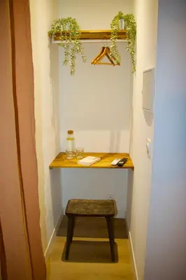 a desk in a hallway with a stool and plants at Maison Merci - Maison d'hôtes in Carcassonne