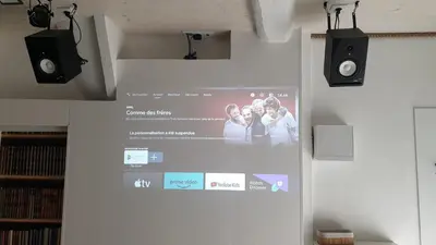 a projection screen on a wall with two speakers at BACKSTAGE STUDIO in Maury