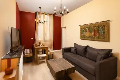 a living room with a couch and a table at Balda'Quand Médiéval in Carcassonne
