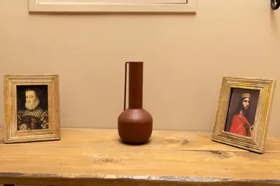 two framed photographs and a vase on a table at Balda'Quand Médiéval in Carcassonne