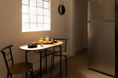 a table with food on it in a room with a window at Balda'Quand Médiéval in Carcassonne