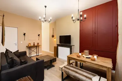 a living room with a couch and a table at Balda'Quand Médiéval in Carcassonne