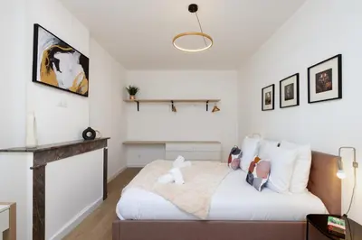 a bedroom with a bed and a couch at MarQue Néo Art in Carcassonne