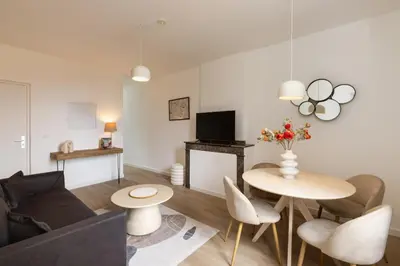 a living room with a table and a couch at MarQue Néo Art in Carcassonne