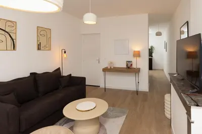 a living room with a couch and a table at MarQue Néo Art in Carcassonne