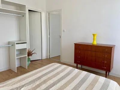 a living room with a table and a couch at Charmant T2 de 48m2 à 300m du centre ville in Lézignan-Corbières