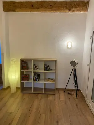 a room with a book shelf and a camera at Maison spacieuse, chaleureuse, Wifi et parking privé in Cases-de-Pène