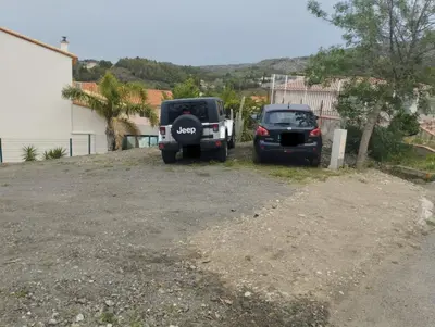 two jeeps parked in a parking lot at Maison spacieuse, chaleureuse, Wifi et parking privé in Cases-de-Pène