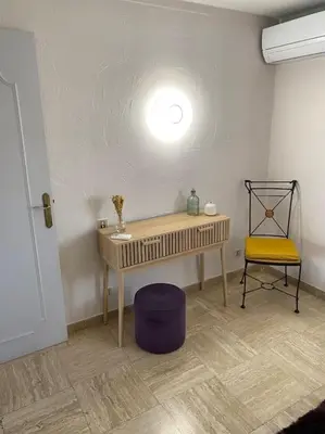 a room with a table and a yellow chair at Appartement spacieux, climatisé, parking privé, wifi et vue imprenable in Cases-de-Pène