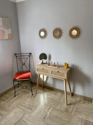 a desk with a chair and two mirrors on a wall at Appartement spacieux, climatisé, parking privé, wifi et vue imprenable in Cases-de-Pène