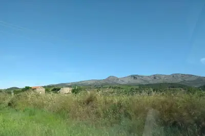 a view of a field with mountains in the background at Appartement neuf tout confort, climatisé, parking privé et wifi in Cases-de-Pène
