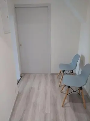 two chairs and a chair in an empty room at Appartement neuf tout confort, climatisé, parking privé et wifi in Cases-de-Pène