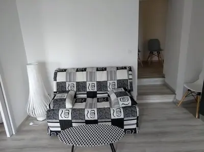 a living room with a couch and a table at Appartement neuf tout confort, climatisé, parking privé et wifi in Cases-de-Pène