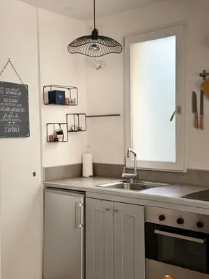 a kitchen with a sink and a window at La vue de la calade in Peyriac-de-Mer