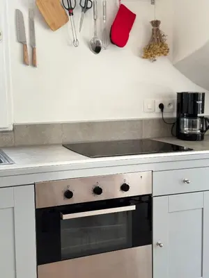 a kitchen with a stove top oven in a kitchen at La vue de la calade in Peyriac-de-Mer