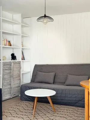 a living room with a couch and a table at La vue de la calade in Peyriac-de-Mer