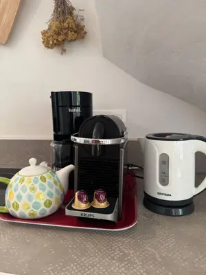 a kitchen counter with a coffee maker and cupcakes at La vue de la calade in Peyriac-de-Mer
