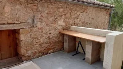 a bench sitting next to a stone wall at Domaine Castel Negre Alet Les Bains in Alet-les-Bains