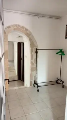 a room with a stone wall and a lamp on a tile floor at Domaine Castel Negre Alet Les Bains in Alet-les-Bains